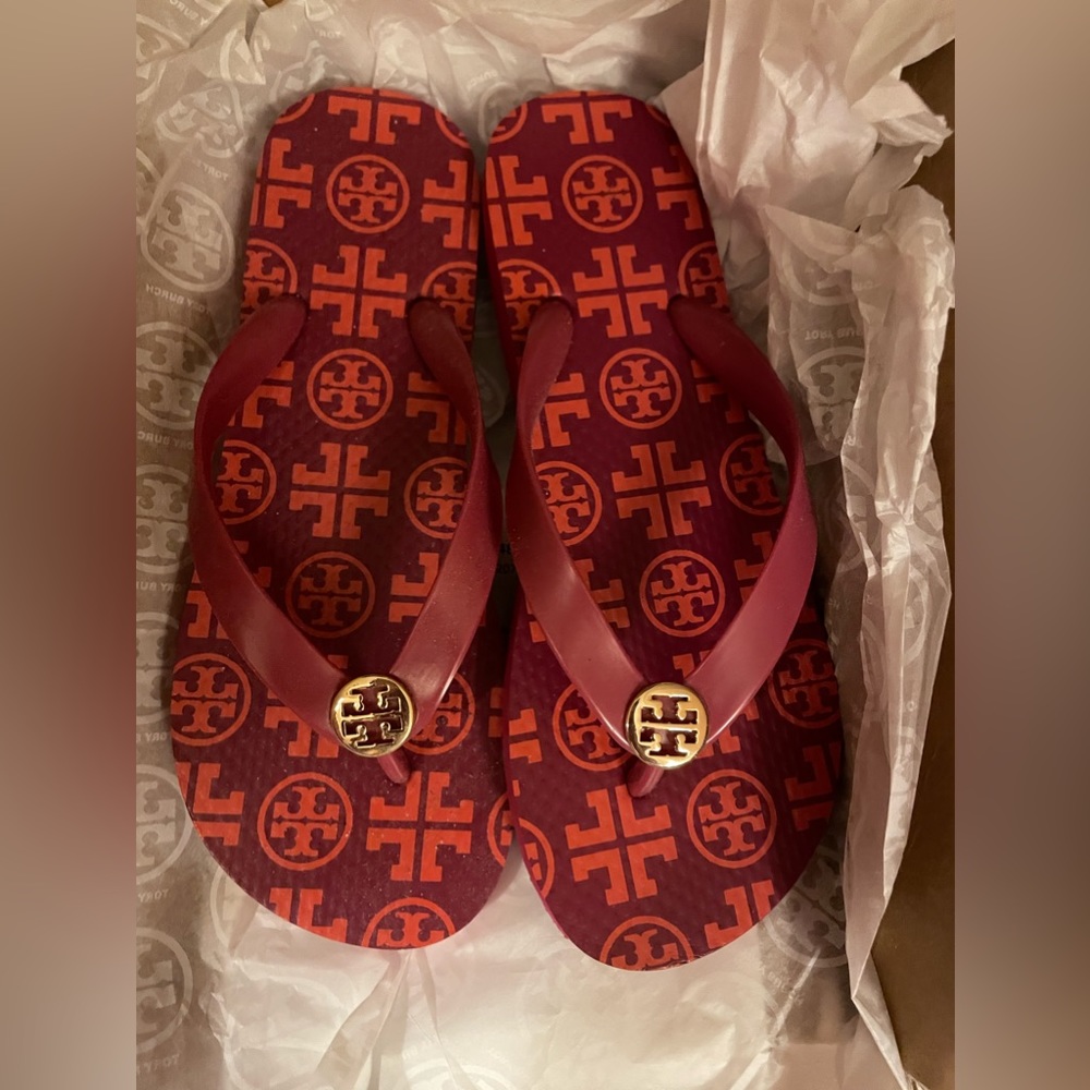 Tory burch fuses flip flops with orange logos